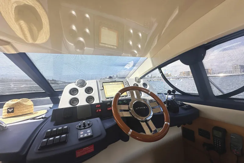 Slide: The Image of Cockpit of 2007 Azimut 43 yacht with steering wheel and navigation controls. - 23