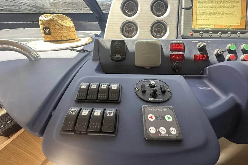 Slide: The Image of Control panel of a 2007 Azimut 43 yacht with switches and navigation instruments. - 25