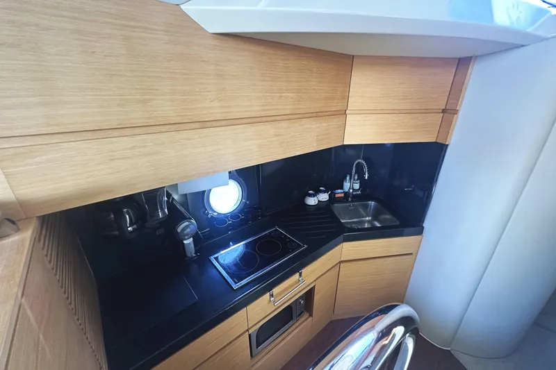 Slide: The Image of Modern kitchen in 2007 Azimut 43 yacht with sleek wood cabinetry and compact appliances. - 28