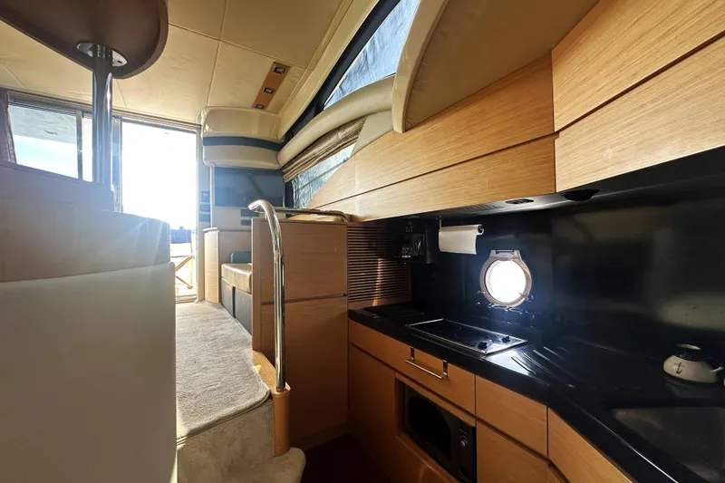 Slide: The Image of Interior of 2007 Azimut 43 yacht, featuring modern kitchen and seating area. - 29