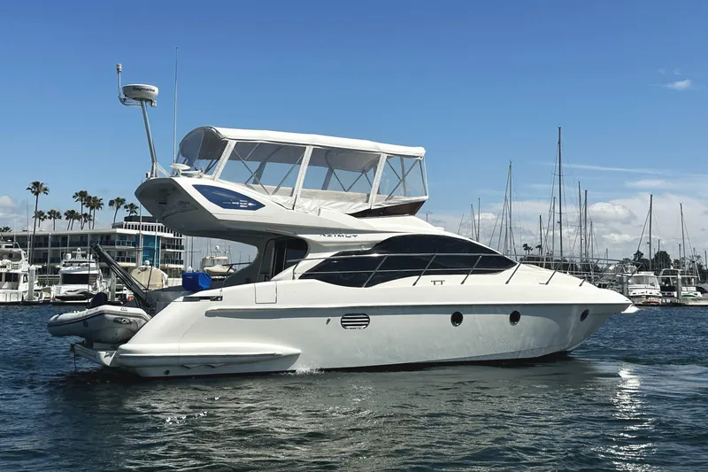 Slide: The Image of 2007 Azimut 43 yacht in marina, clear sky, calm water, luxury boating. - 3