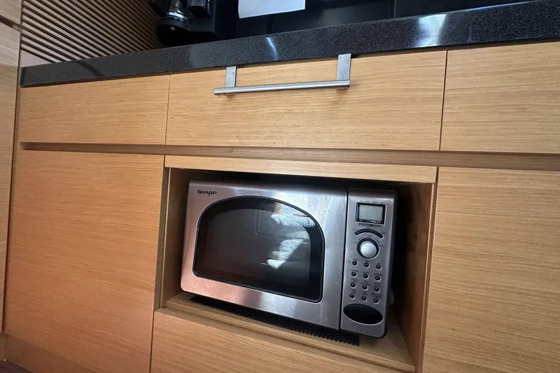 Slide: The Image of Microwave in wooden cabinet on 2007 Azimut 43 yacht kitchen. - 30