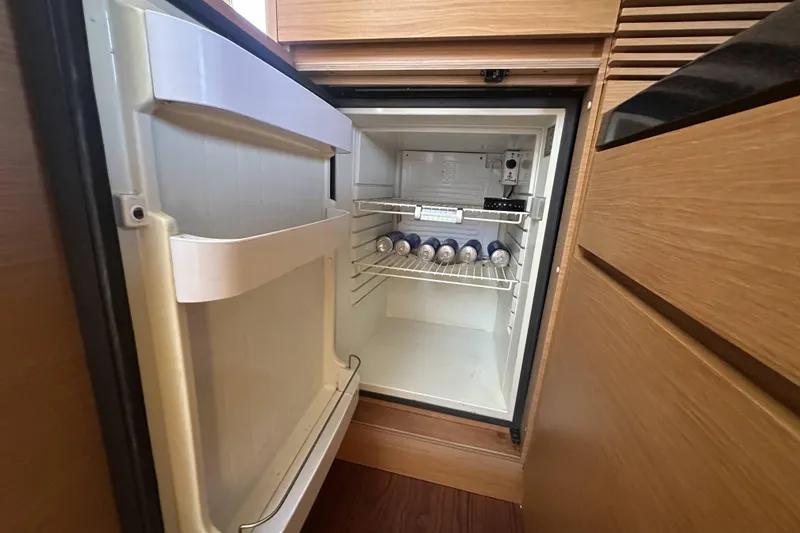 Slide: The Image of Open fridge in 2007 Azimut 43 yacht, stocked with canned beverages. - 31