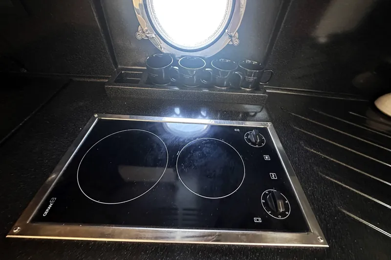 Slide: The Image of Stovetop in 2007 Azimut 43 yacht kitchen with porthole and mugs. - 33