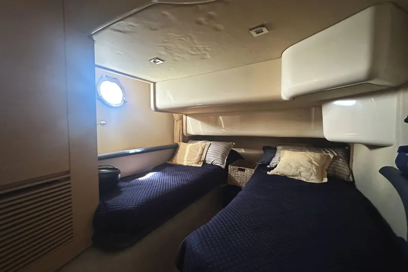 Slide: The Image of 2007 Azimut 43 yacht cabin with twin beds and porthole window. - 38