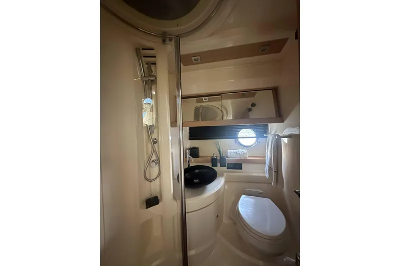 Slide: The Image of Luxurious bathroom in a 2007 Azimut 43 yacht with modern fixtures and porthole window. - 39