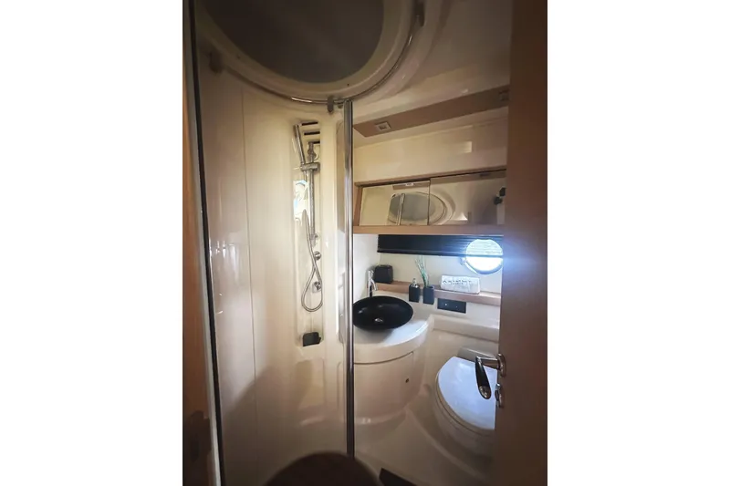 Slide: The Image of Luxurious bathroom in 2007 Azimut 43 yacht with modern fixtures and porthole window. - 40