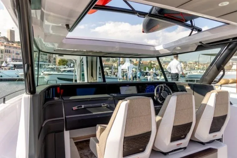 Slide: The Image of Interior view of 2027 Axopar 45 Cross Top boat with modern seating and dashboard. - 3