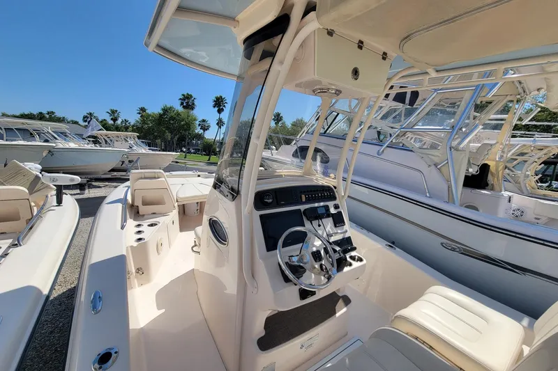 Slide: The Image of 2017 Grady-White 251 Coastal Explorer boat interior with steering console and seating. - 11