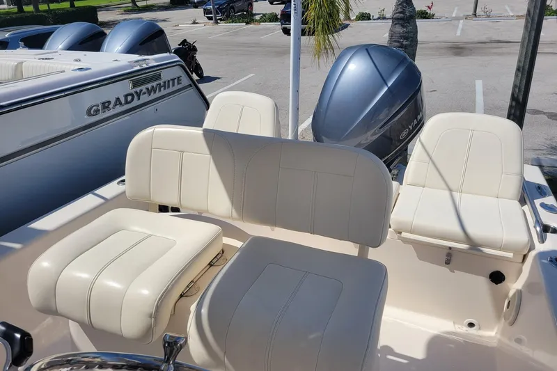 Slide: The Image of 2017 Grady-White 251 Coastal Explorer boat interior with white seating and Yamaha engine. - 12