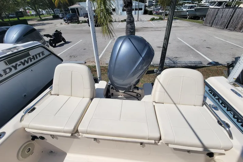 Slide: The Image of 2017 Grady-White 251 Coastal Explorer boat with cushioned seating and outboard motor. - 13