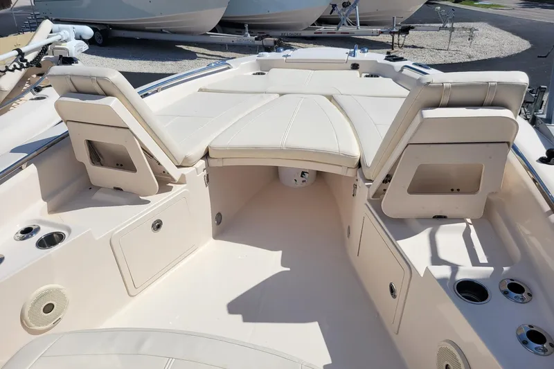 Slide: The Image of 2017 Grady-White 251 Coastal Explorer boat interior with cushioned seating and storage compartments. - 16