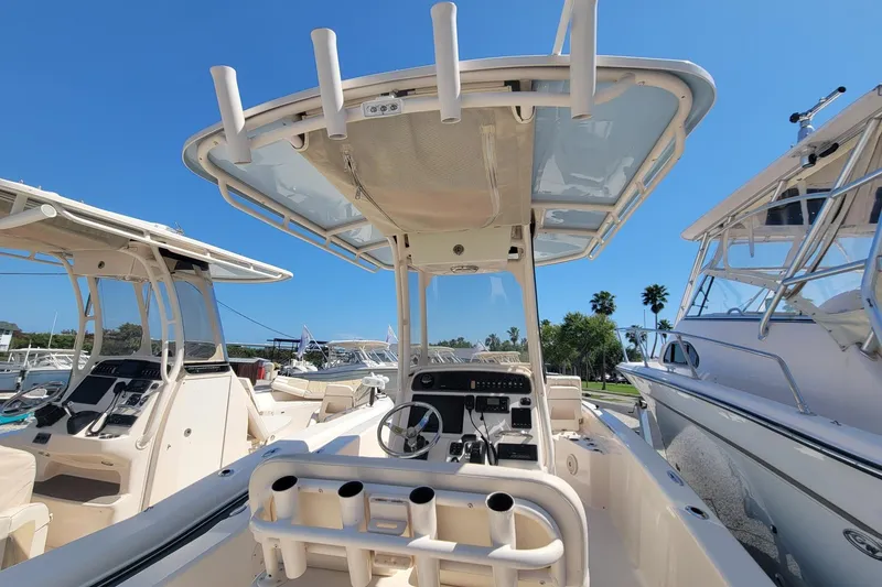 Slide: The Image of 2017 Grady-White 251 Coastal Explorer boat with center console and T-top in marina. - 4