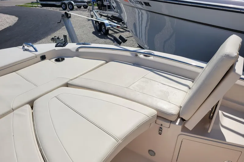 Slide: The Image of 2017 Grady-White 251 Coastal Explorer boat interior with cushioned seating and cup holder. - 7