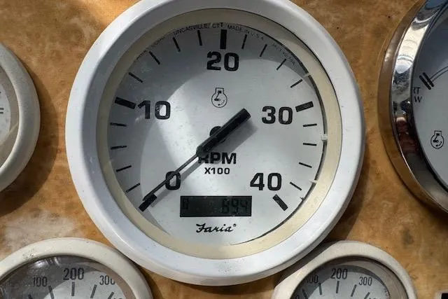 Slide: The Image of RPM gauge on 1999 Cruisers 3870 Express boat dashboard, showing 699 RPM. - 11