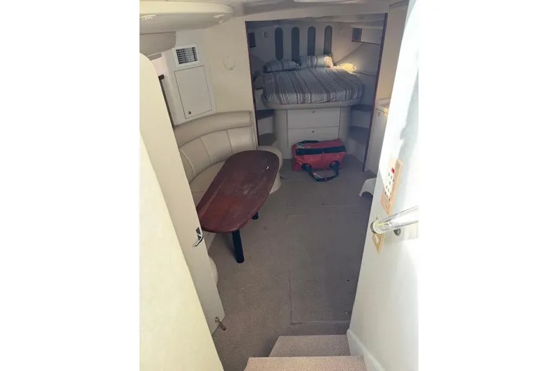 Slide: The Image of 1999 Cruisers 3870 Express cabin interior with bed, seating, and table. - 12