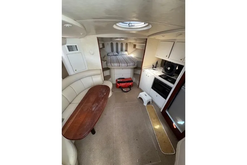 Slide: The Image of Interior of 1999 Cruisers 3870 Express yacht with kitchen, dining area, and bed. - 13