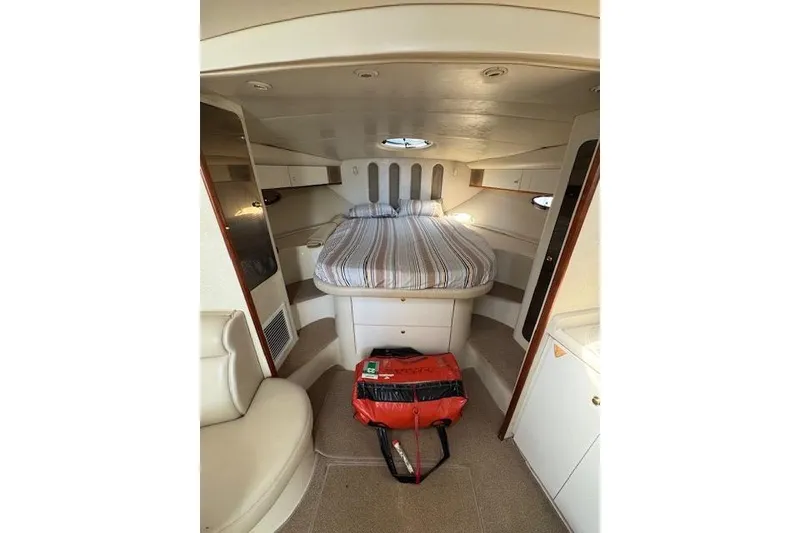 Slide: The Image of 1999 Cruisers 3870 Express cabin interior with bed and seating area. - 14