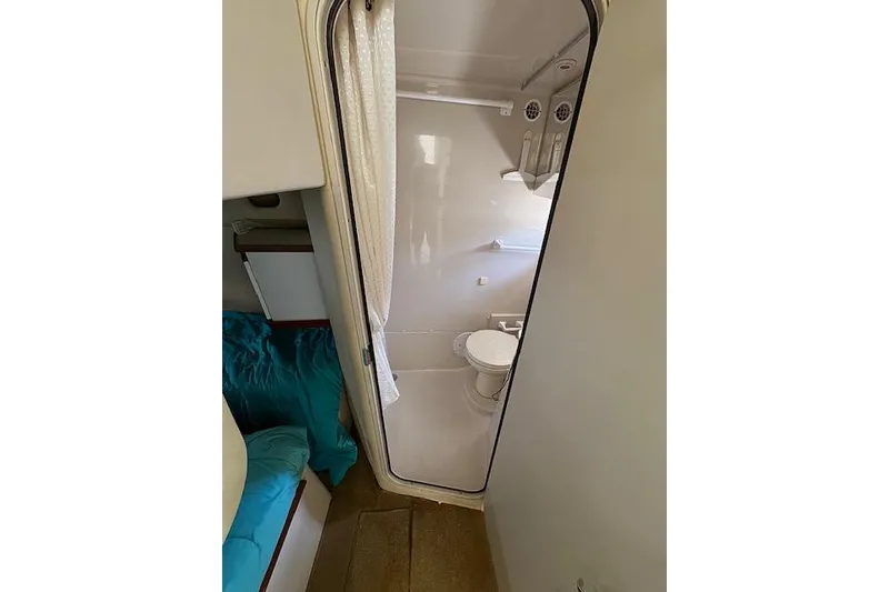 Slide: The Image of 1999 Cruisers 3870 Express yacht bathroom interior with shower and toilet. - 21