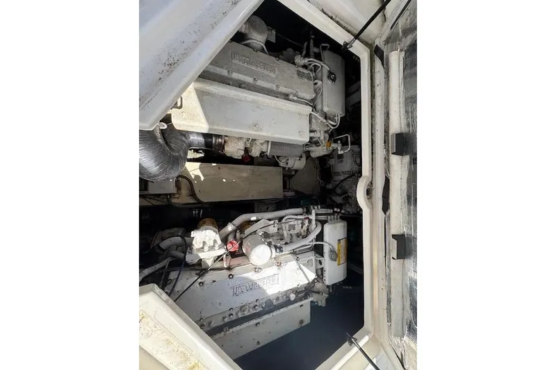 Slide: The Image of Engine compartment of a 1999 Cruisers 3870 Express boat, showcasing mechanical components. - 25