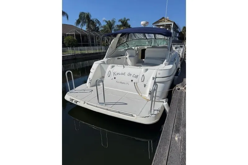 Slide: The Image of 1999 Cruisers 3870 Express yacht docked, featuring spacious deck and seating, Fort Myers, FL. - 5