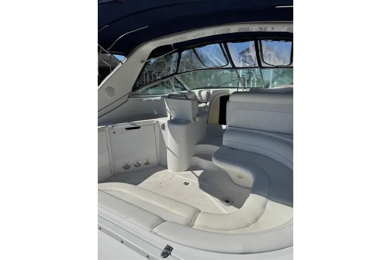 Slide: The Image of 1999 Cruisers 3870 Express boat interior with white seating and covered cockpit. - 7