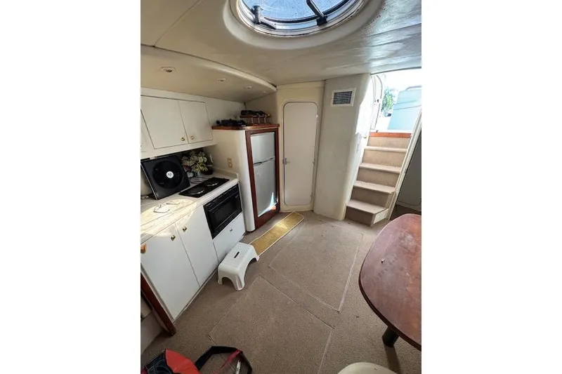 Slide: The Image of Interior of 1999 Cruisers 3870 Express yacht with kitchenette and stairs. - 15