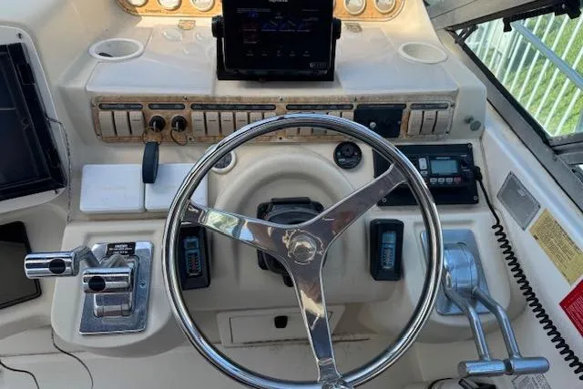 Slide: The Image of 1999 Cruisers 3870 Express helm with steering wheel and control panel. - 9