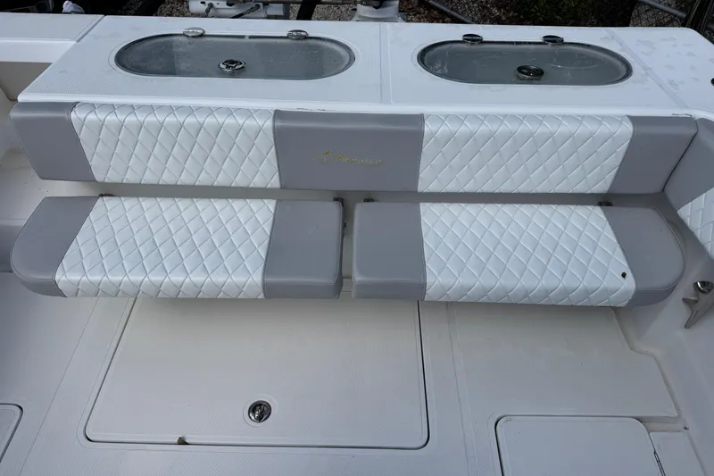 Slide: The Image of 2014 Blackwater 36 Sportfish boat seating with quilted upholstery and livewell compartments. - 11