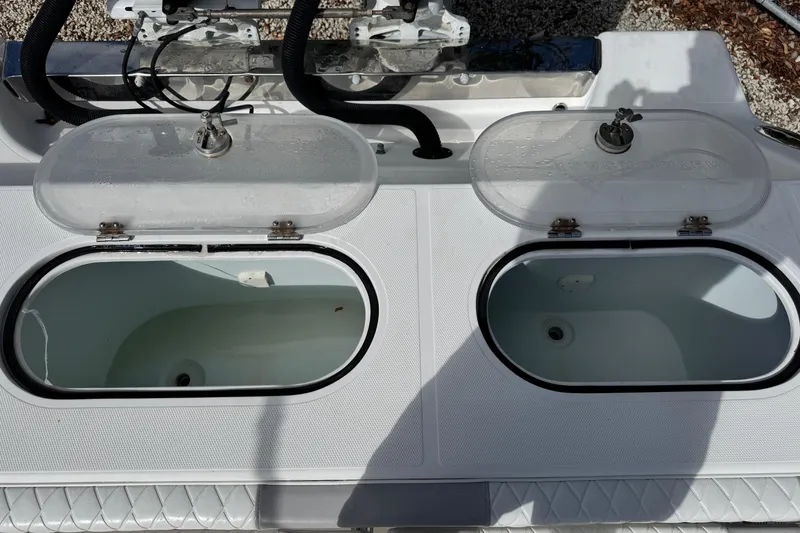 Slide: The Image of Open livewells on a 2014 Blackwater 36 Sportfish boat, showcasing fishing equipment. - 12