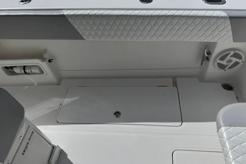 Slide: The Image of Interior of 2014 Blackwater 36 Sportfish boat, featuring quilted upholstery and storage compartments. - 13