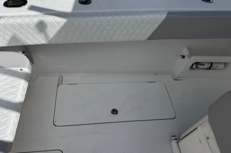 Slide: The Image of Interior of a 2014 Blackwater 36 Sportfish boat, featuring white quilted seating. - 14