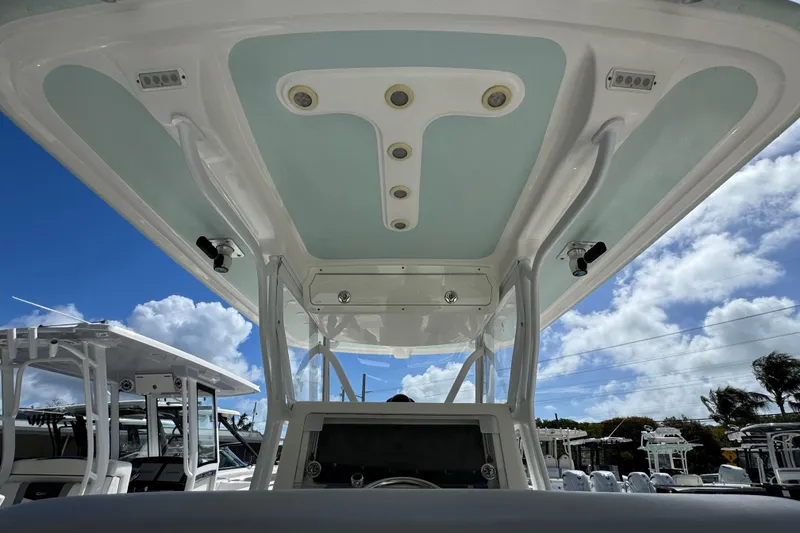 Slide: The Image of 2014 Blackwater 36 Sportfish boat interior with T-top under blue sky. - 17