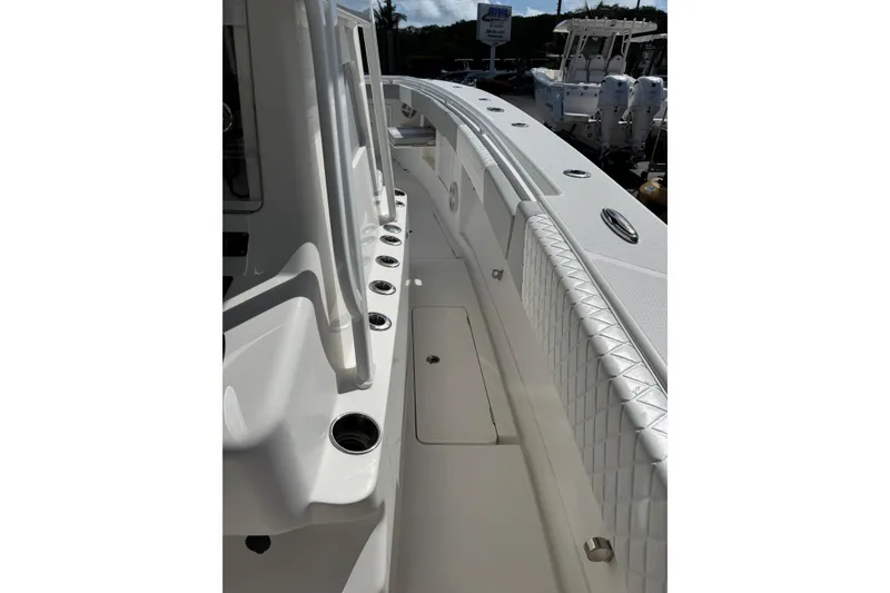 Slide: The Image of Side view of 2014 Blackwater 36 Sportfish boat, showcasing sleek design and rod holders. - 25