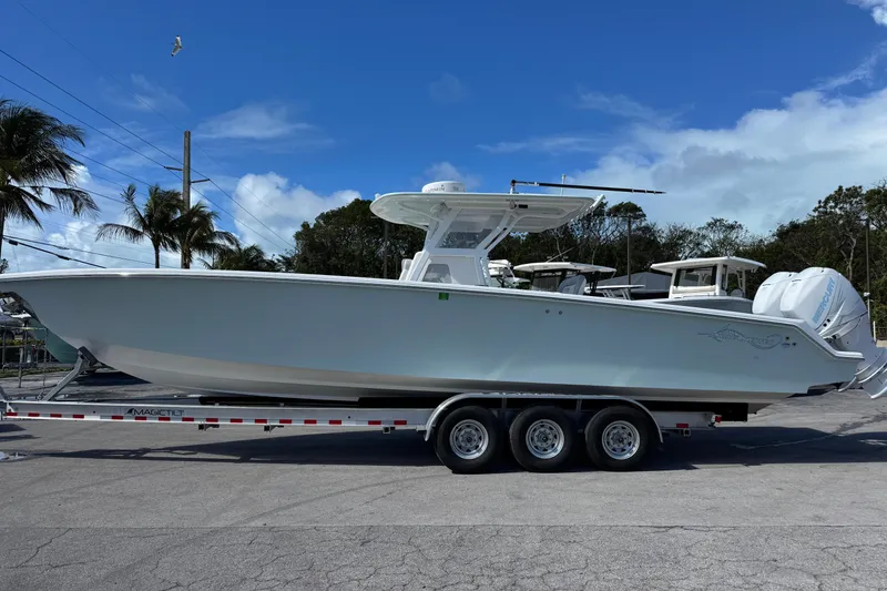 Slide: The Image of 2014 Blackwater 36 Sportfish boat on trailer, parked outdoors under blue sky. - 3