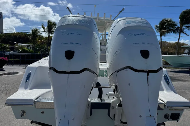 Slide: The Image of Twin outboard engines on a 2014 Blackwater 36 Sportfish boat, parked outdoors. - 4