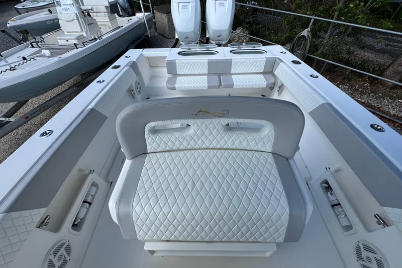 Slide: The Image of 2014 Blackwater 36 Sportfish boat interior with white quilted seating and dual engines. - 40