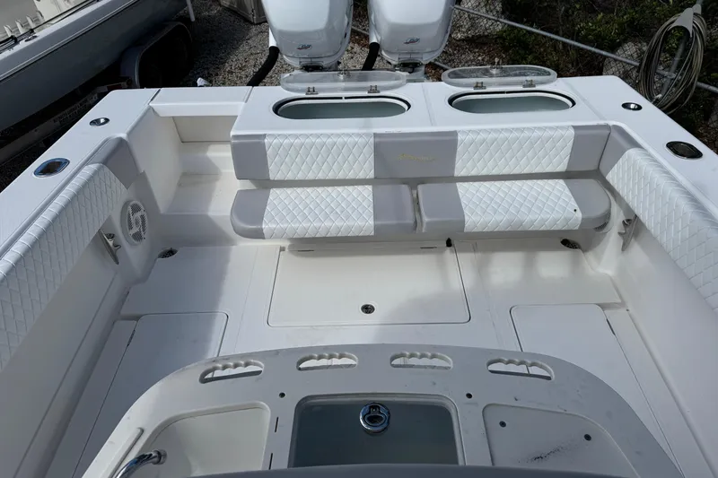 Slide: The Image of 2014 Blackwater 36 Sportfish boat interior with white quilted seating and dual engines. - 41