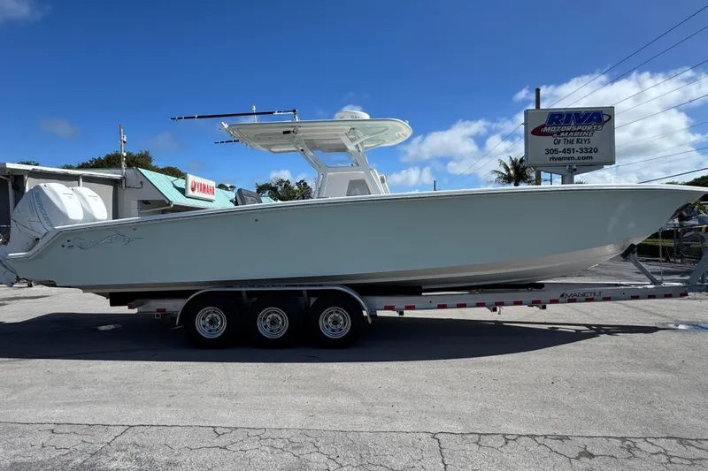 Slide: The Image of 2014 Blackwater 36 Sportfish boat on trailer at dealership under clear blue sky. - 5
