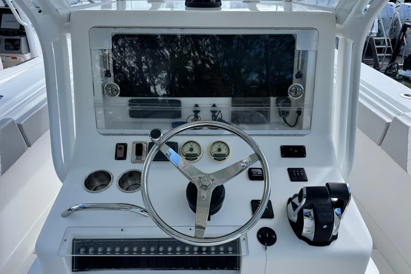 Slide: The Image of Control panel of a 2014 Blackwater 36 Sportfish boat with steering wheel and gauges. - 9