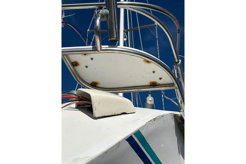 Slide: The Image of Close-up of a 1996 Catalina 36 MkII sailboat's deck and railing under a clear blue sky. - 11