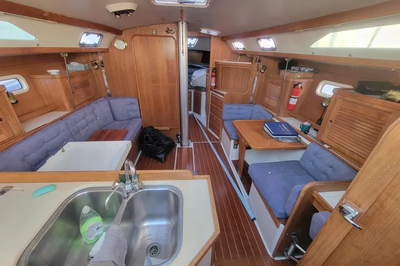 Slide: The Image of Interior of a 1996 Catalina 36 MkII sailboat with wooden furnishings and seating. - 15