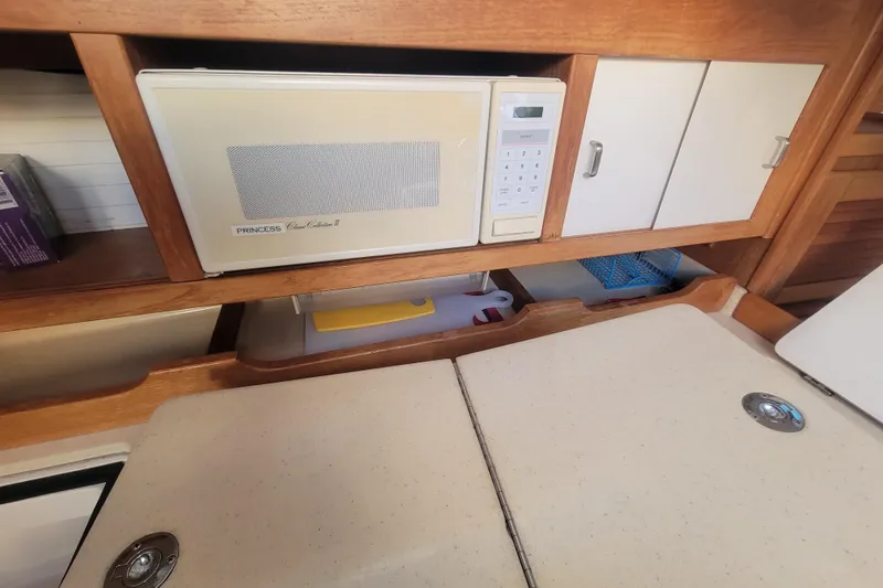 Slide: The Image of Interior of 1996 Catalina 36 MkII yacht with microwave and storage cabinets. - 18