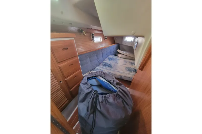 Slide: The Image of Interior cabin of a 1996 Catalina 36 MkII sailboat with wooden drawers and cushioned seating. - 23