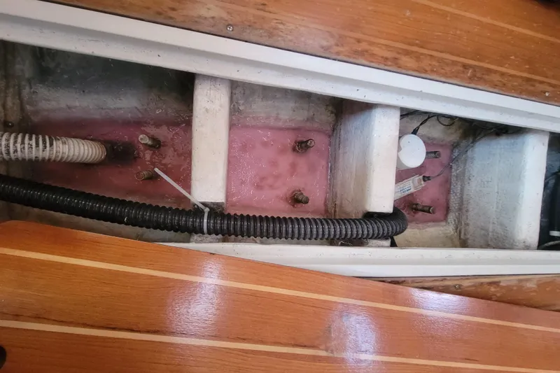 Slide: The Image of Interior view of a 1996 Catalina 36 MkII sailboat's bilge area with visible wiring and hoses. - 26