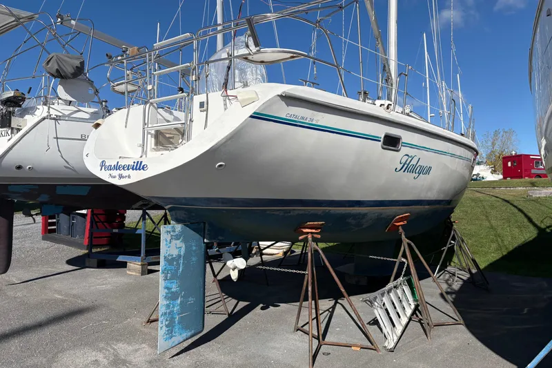 Slide: The Image of 1996 Catalina 36 MkII sailboat on stands, named "Halcyon," in a boatyard. - 3