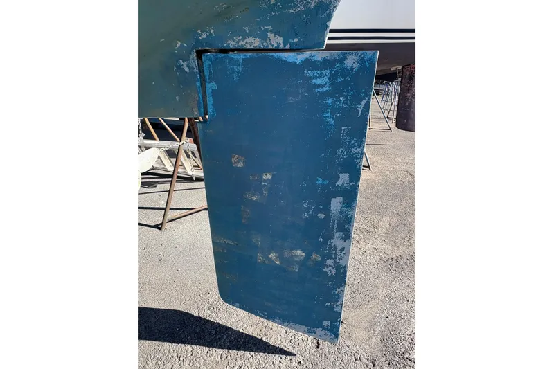 Slide: The Image of Rudder of a 1996 Catalina 36 MkII sailboat, showing wear and blue paint. - 5
