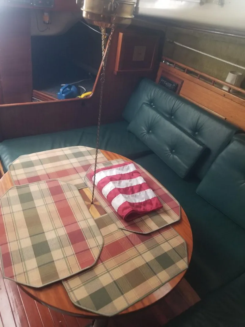 Slide: The Image of Interior of a 1964 Columbia 33 sailboat with a cozy dining area. - 14