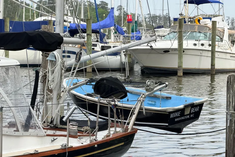 Slide: The Image of Boats docked at a marina, featuring a 1964 Columbia 33 sailboat. - 19