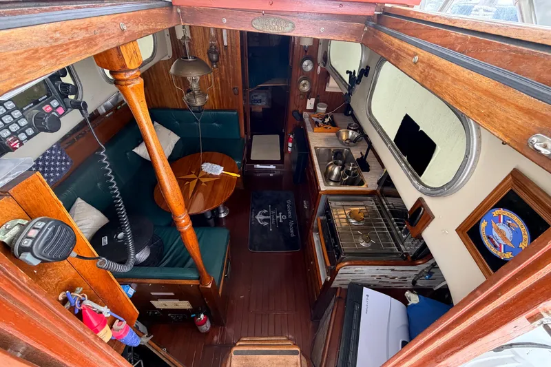 Slide: The Image of Interior of a 1964 Columbia 33 sailboat with wood finishes and compact kitchen. - 26